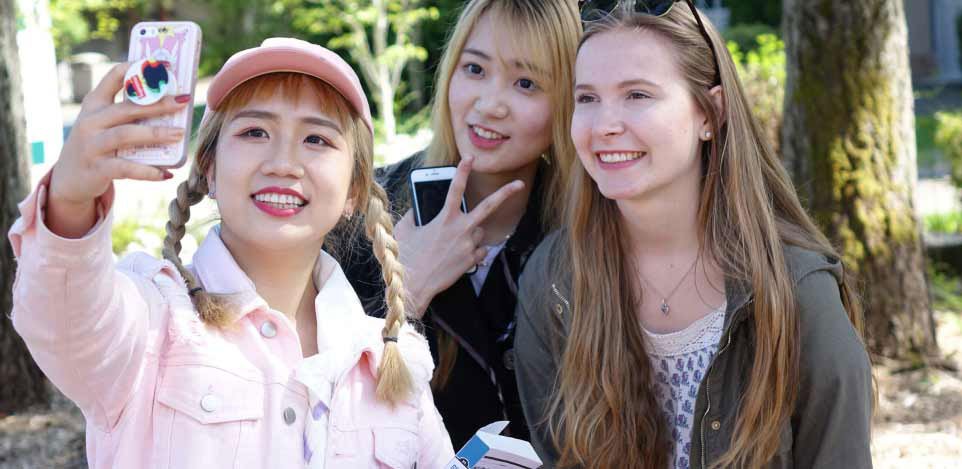 three female students take a selfie