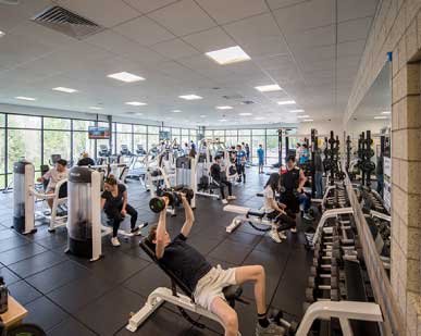 large modern gym with people exercising