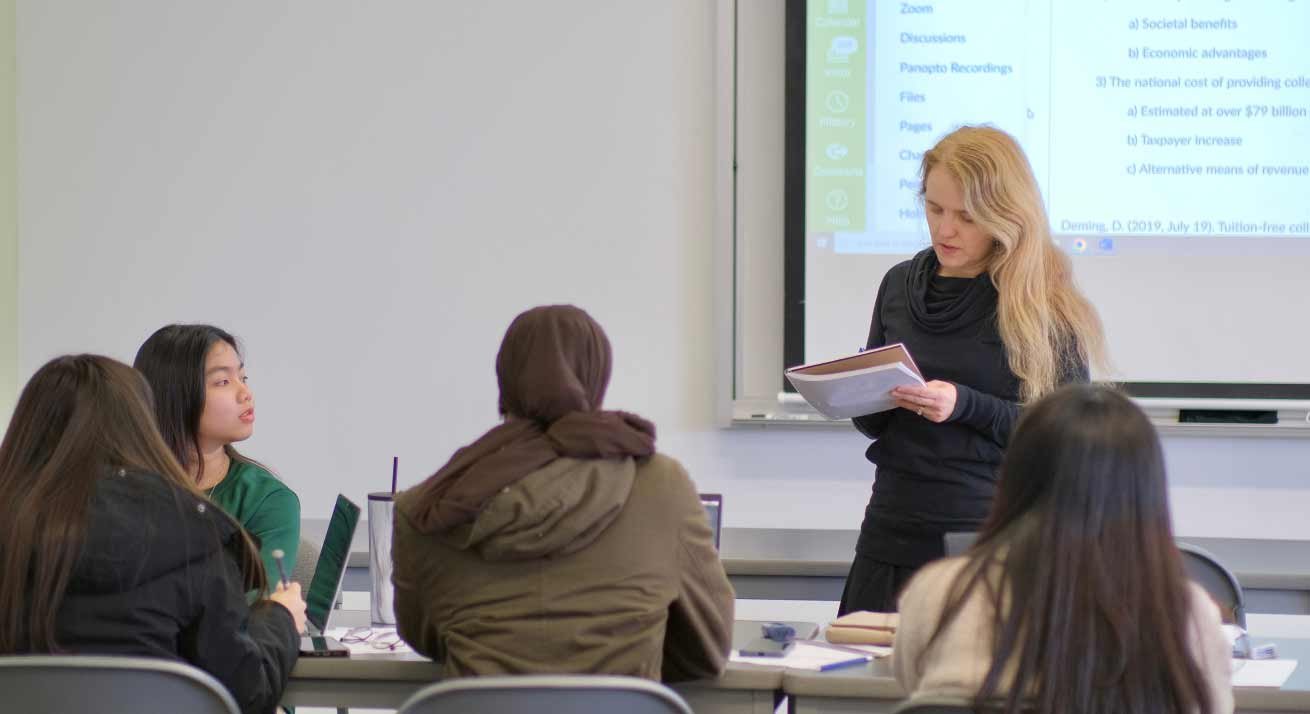 a female instructor leads class of students